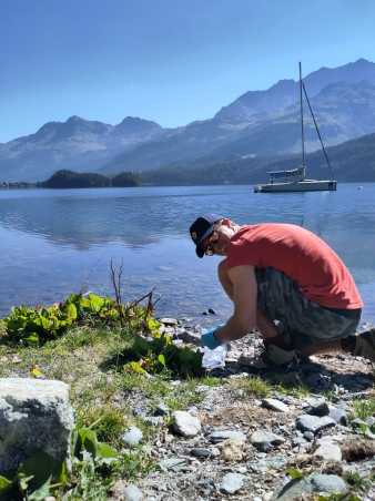 Scientist sampling eDNA at lake Silvaplana